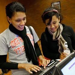 Alumni using computer to sign up for benefits
